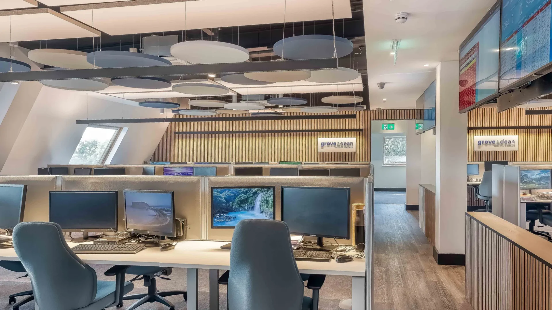 Photo of call centre workplace interior with warm LED lighting and contemporary architectural design