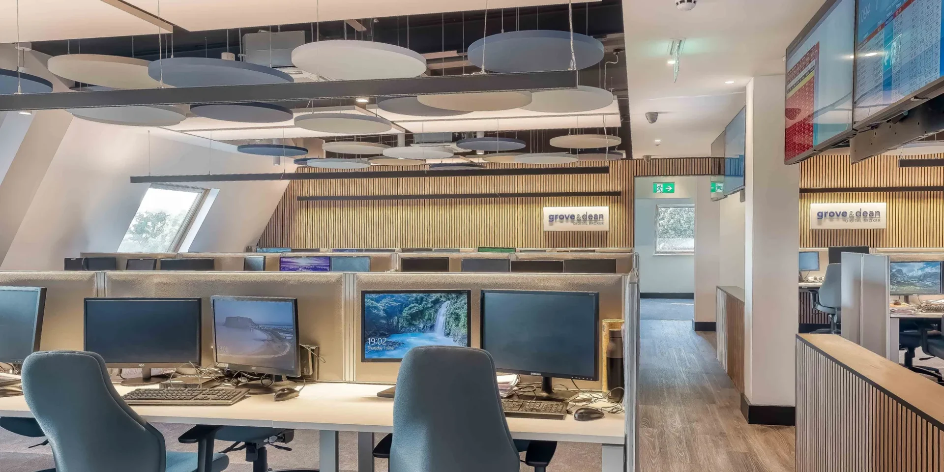 Photo of call centre workplace interior with warm LED lighting and contemporary architectural design