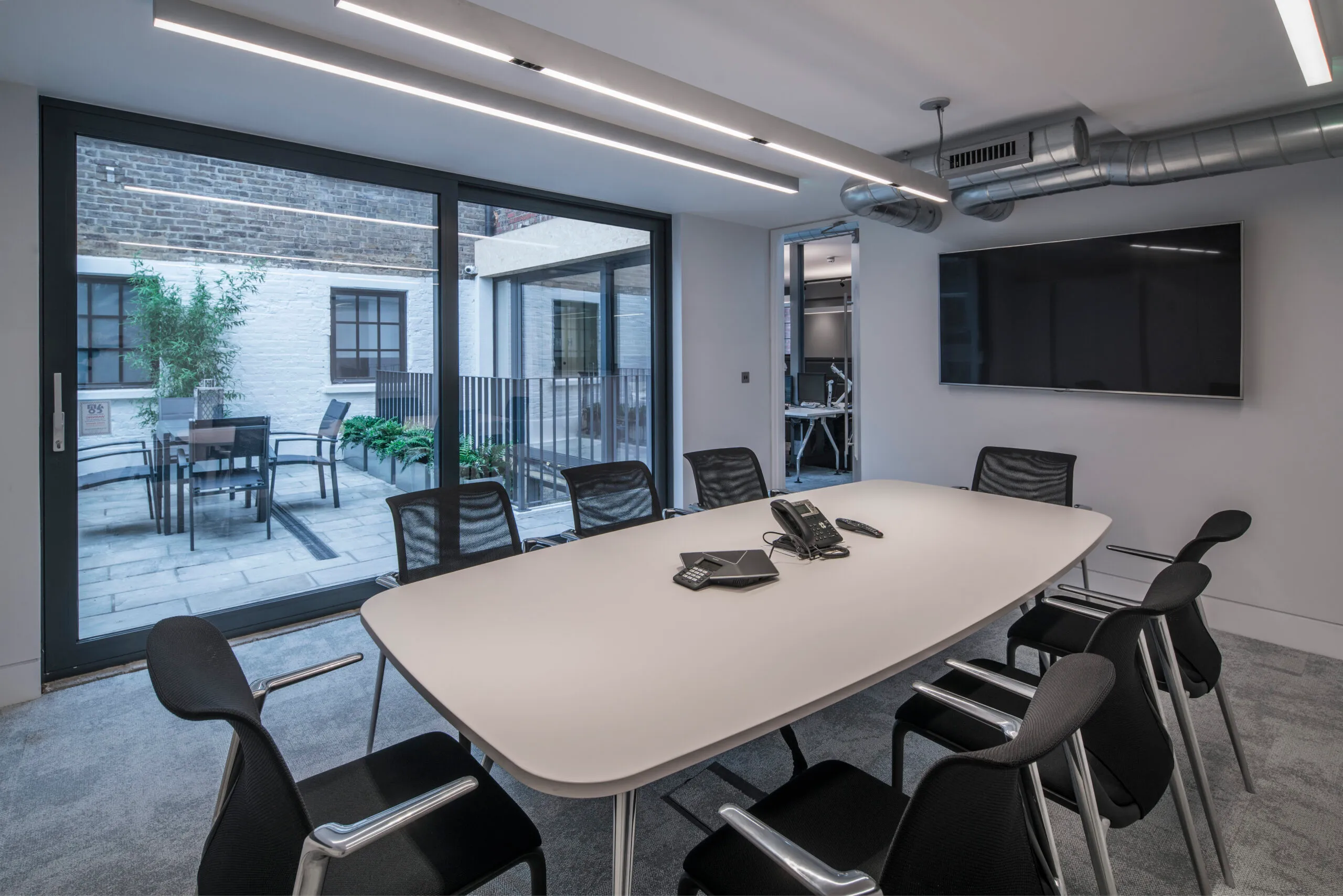 Photo of charterhouse historic building conference room with contemporary lighting design and modern interior