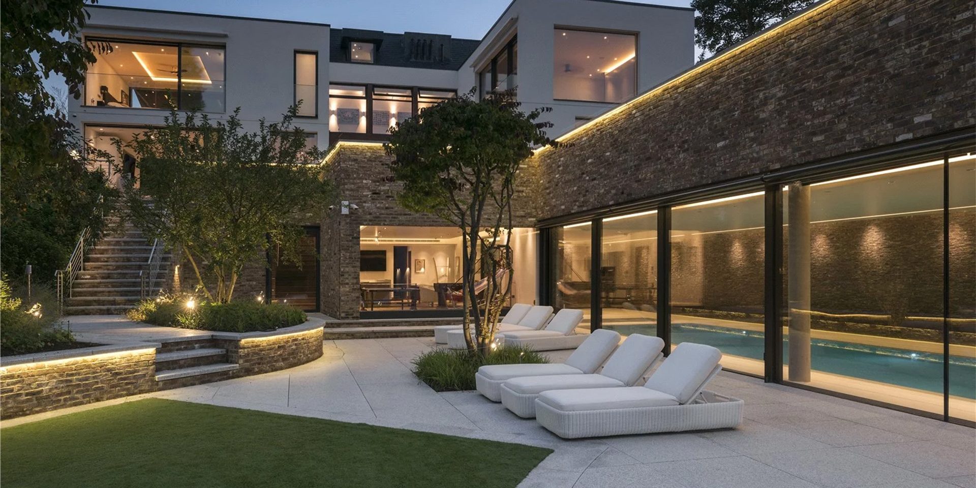 Photo of cobham surrey residential property exterior with ambient outdoor pathway lighting and contemporary architecture