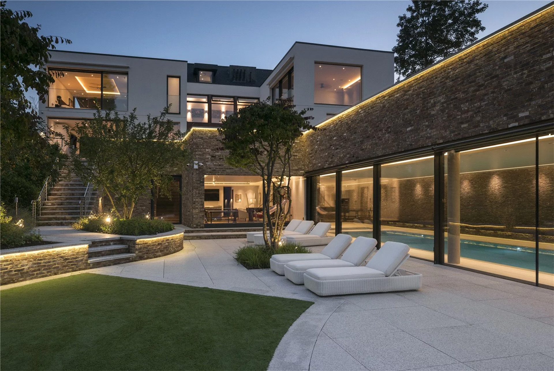 Photo of cobham surrey residential property exterior with ambient outdoor pathway lighting and contemporary architecture