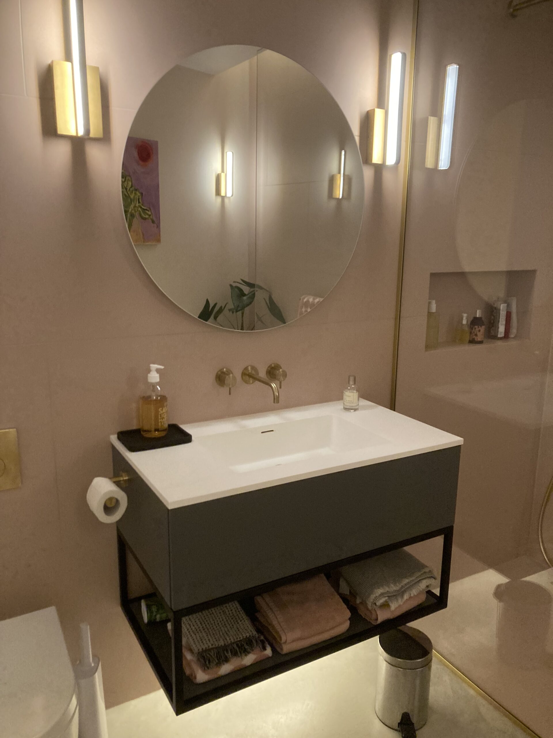 Photo of east dulwich grand designs modern bathroom with circular mirror and minimalist fixtures