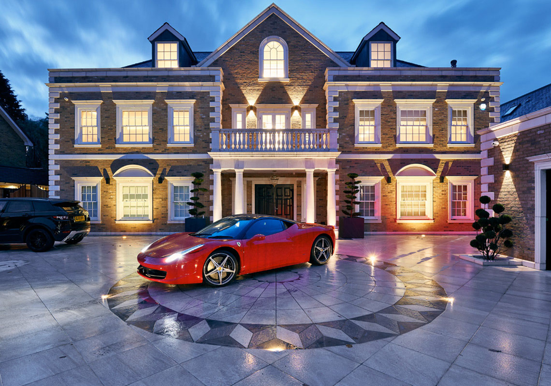 Photo of elm grove luxury residence exterior with warm evening ambient lighting and contemporary architecture
