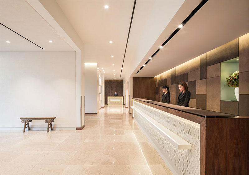 Photo of metropolitan hotel park lane lobby with warm ambient lighting and luxury walnut wood finishes