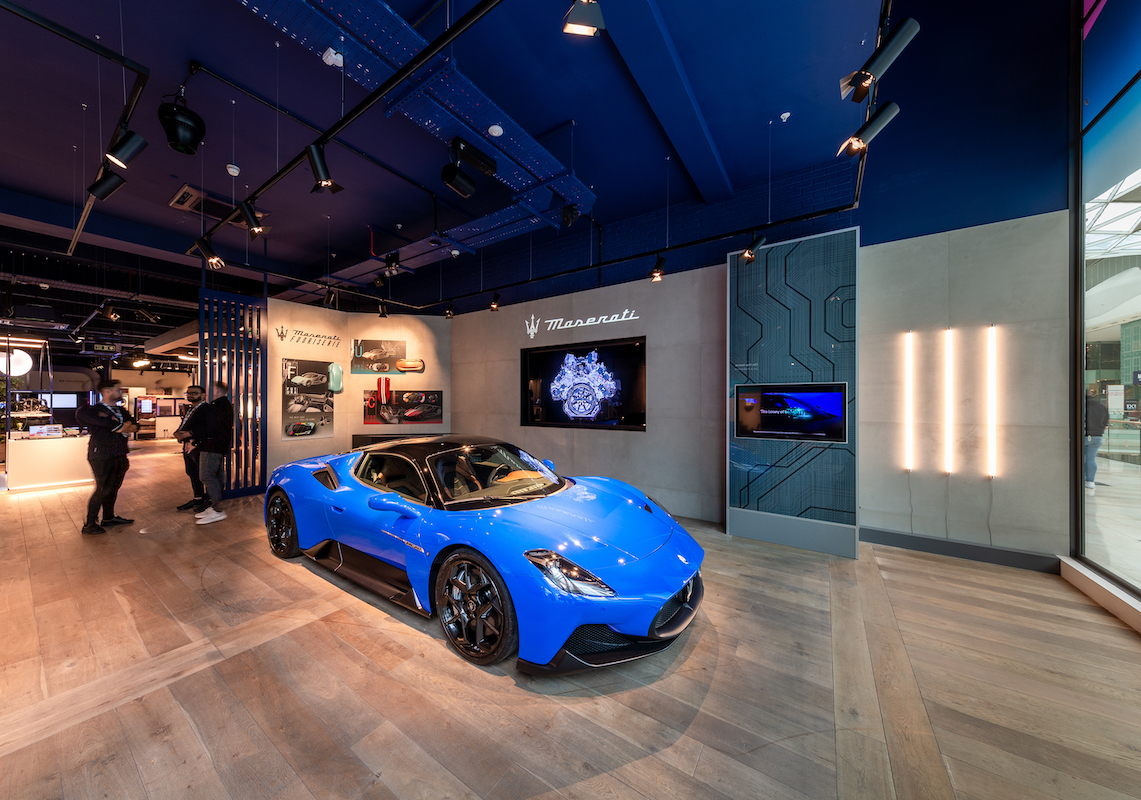 Photo of situ live product showcase space with blue architectural lighting and contemporary retail display design