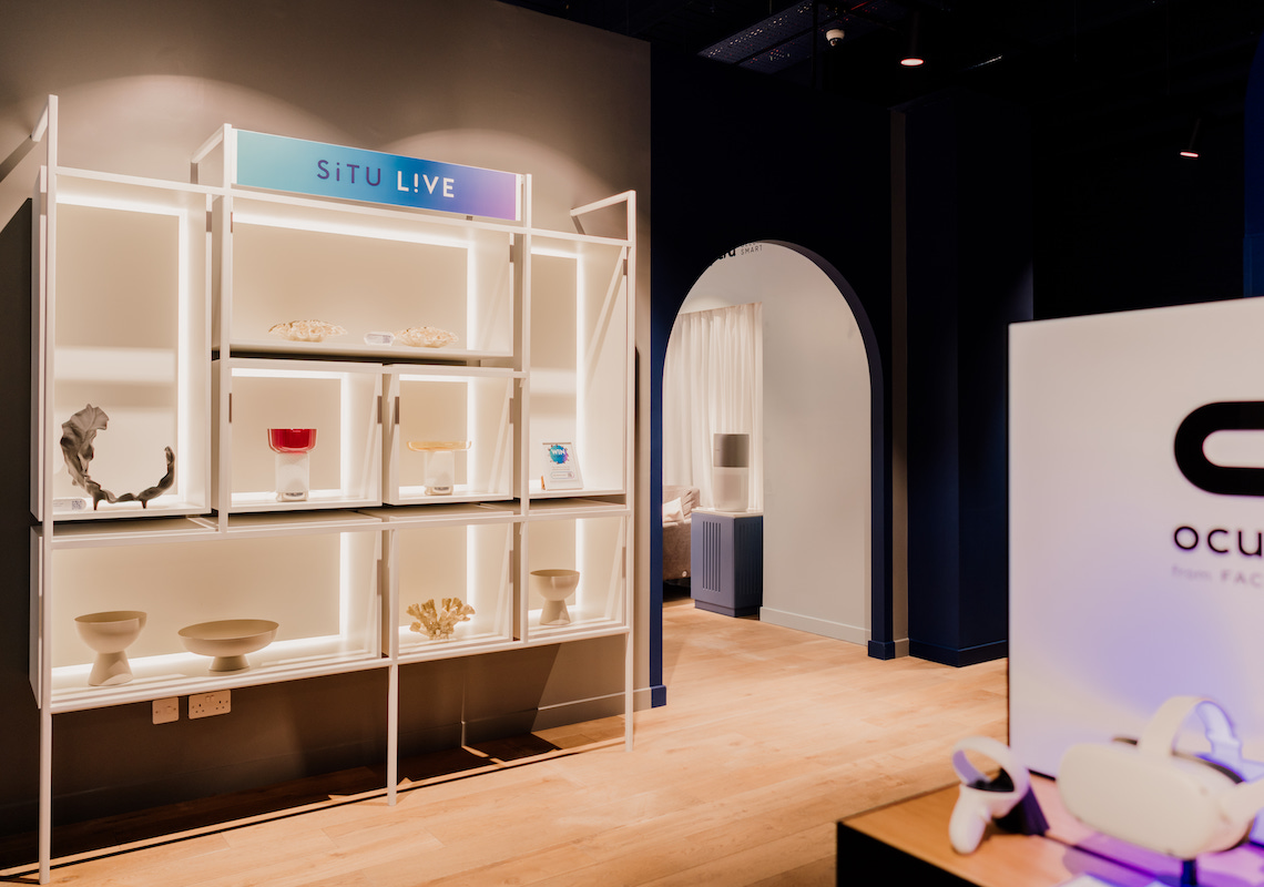 Photo of situ live retail concept space with blue theatrical lighting and contemporary display design