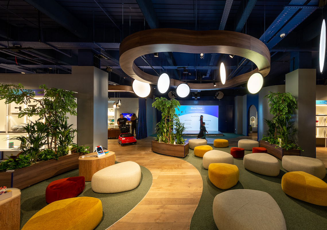 Photo of situ live consultancy space with modern suspended pendant lighting, colourful seating design and contemporary planting