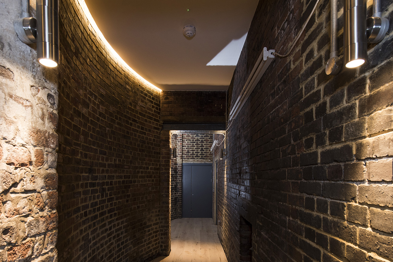 zetland-house-industrial-heritage-lighting Photo of zetland house industrial heritage corridor with warm ambient lighting and exposed brick features
