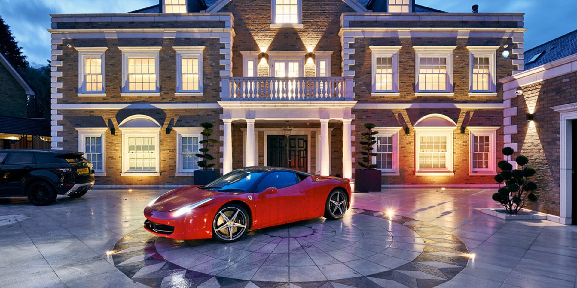 Photo of elm grove luxury residence exterior with warm evening ambient lighting and contemporary architecture