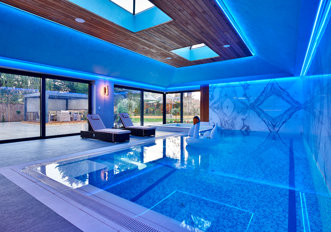 Photo of elm grove residential swimming pool with contemporary blue ambient lighting and luxury design